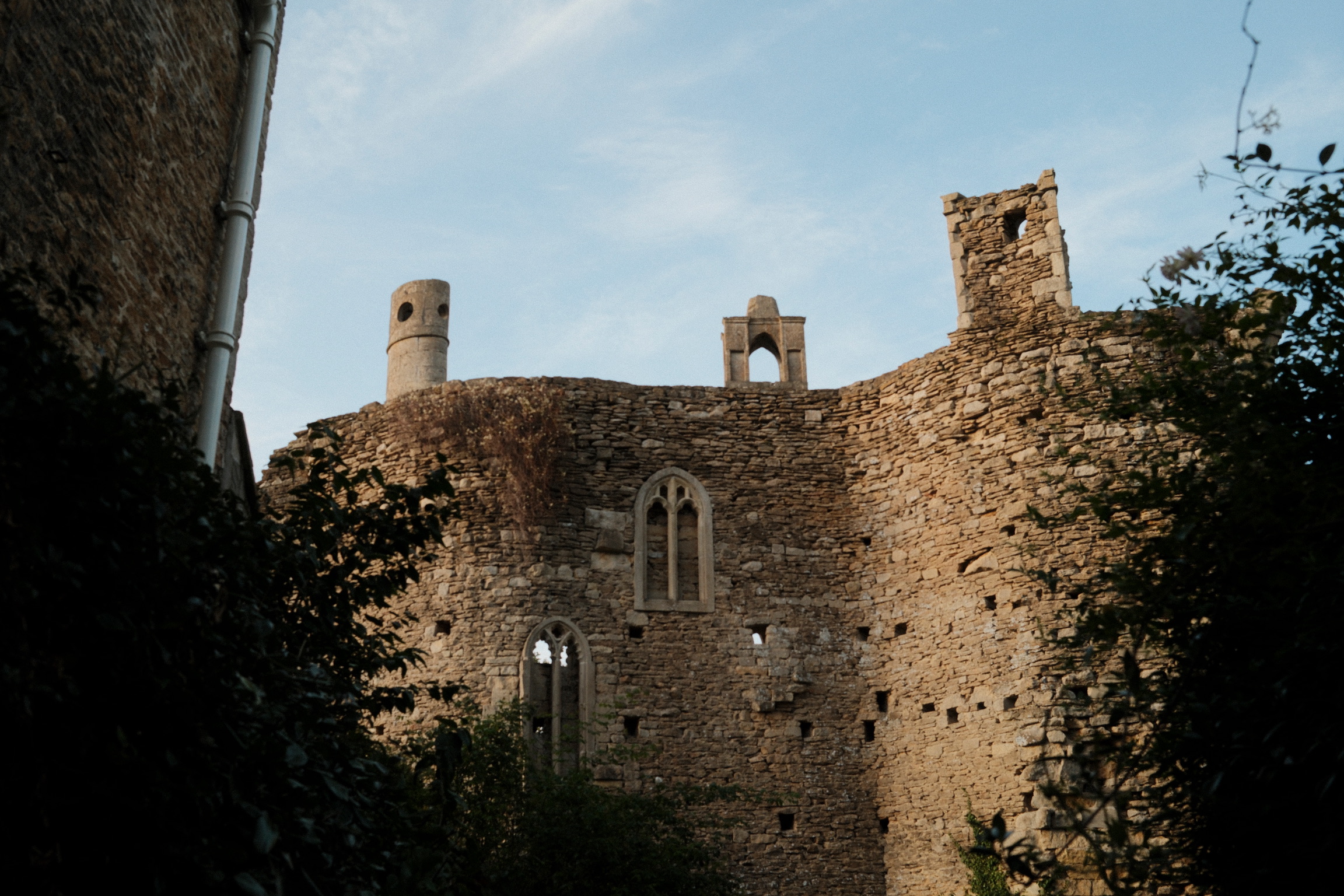 Weathered stone ruins and a window beneath a pale sky